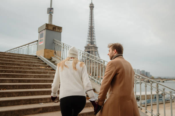 Couple walking along the Seine River in Paris